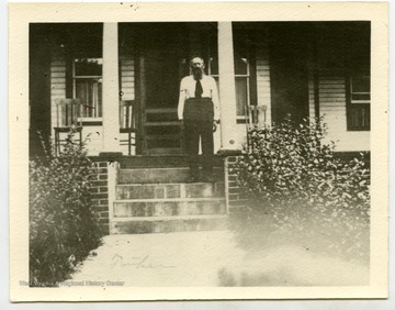 Devil Anse Hatfield on the steps of his family home.
